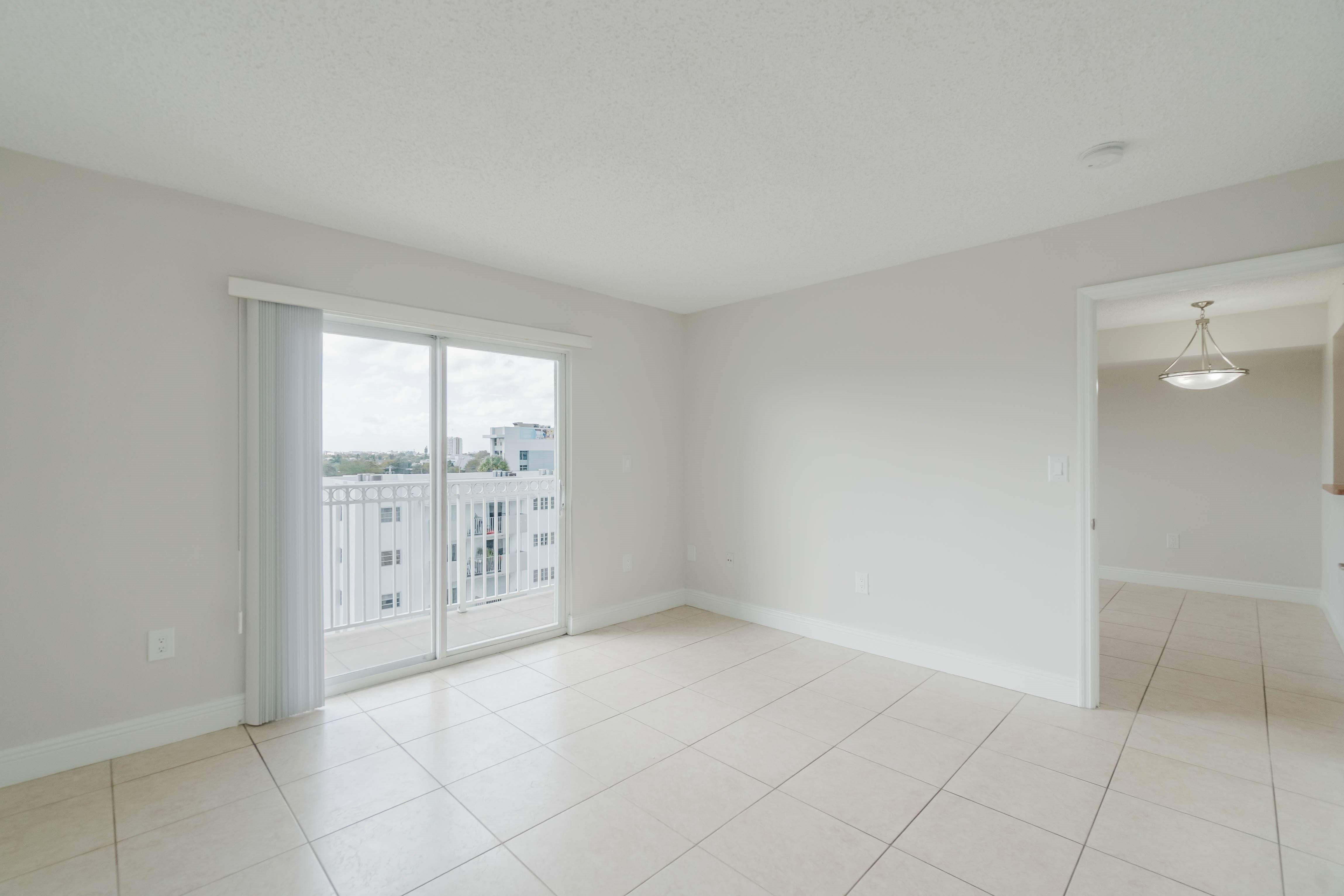 A large empty room with a sliding glass door.
